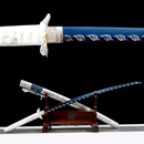 Blue and white katana with intricate leaf designs, displayed on a wooden stand, showcasing elegance and craftsmanship. Fuyu Katana .