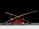 Guren Katana 紅蓮 — San-Mai Red Roast folded steel blade, copper dragon fittings, crimson marbled lacquer saya, black ito handle.