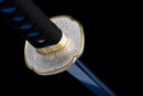 Close-up of katana handle wrapped in black and blue cord with detailed silver-gold guard on a dark background, Aoi Ryū Katana.