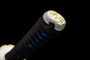 Close-up of a katana handle with black wrapping, blue accents, and ornate silver-and-gold end cap design. Aoi Ryū Katana.