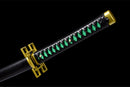 Black and green handle of a katana with a gold geometric guard on a black background, Tokito Muichiro Katana.