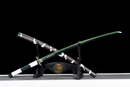 A black and green katana with a white hilt is displayed on a stand with a dragon emblem, featuring a wavy green blade. Sanemi Shinazugawa...