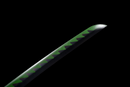 Green and black katana blade with a serrated pattern on a black background, close-up angle. Sanemi Shinazugawa Katana.