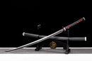 A polished katana with a black and red handle, resting on a black stand with dragon designs against a dark backdrop. Tanjiro Katana.