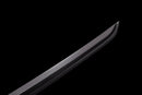 Sleek curved edge of a polished steel katana blade against a black background, sharp tip in focus. Tanjiro Katana.