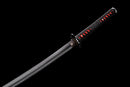 Close-up of a sleek katana with a black and red handle and a shiny, curved steel blade on a black background. Tanjiro Katana.