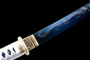Close-up of a blue tanto with intricate dragon engraving, gold guard, and white wrap handle. Ryūjin Tanto Ryujin Tanto.