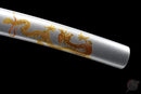 Polished silver tanto sheath with intricate golden dragon design, angled view, black background. Ryūjin Tanto Ryujin at the end.